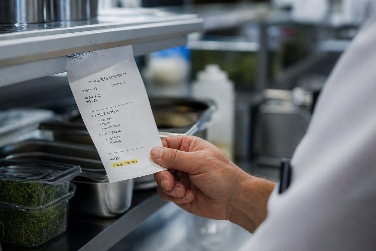 Kitchen ticket showing customer allergy note submitted with order